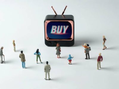 People figurines watching "Buy" instruction on TV. Post-truth concept